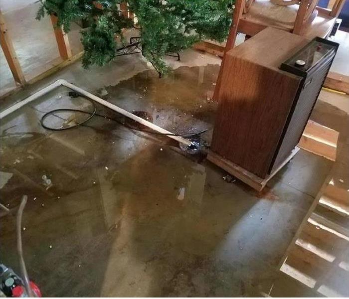 pooling dirty water on the concrete floor, bare studs, and plates visible along with the steps platform