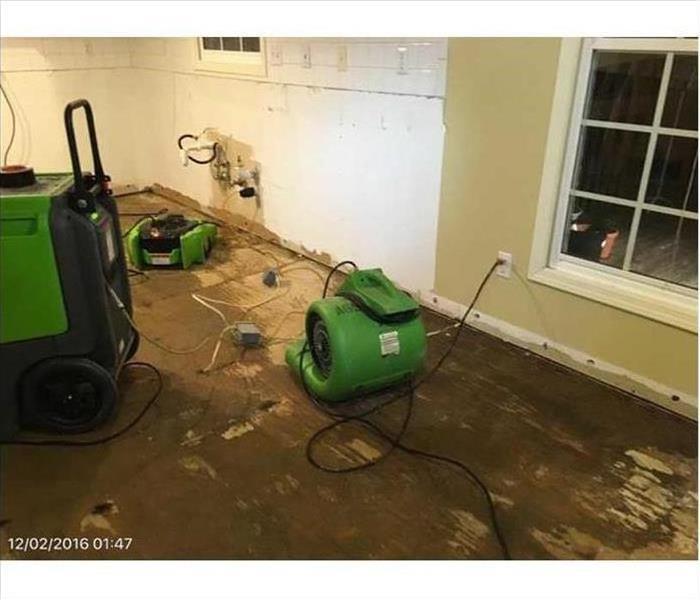 Our air movers and dehumidifiers working to dry the floor in this home