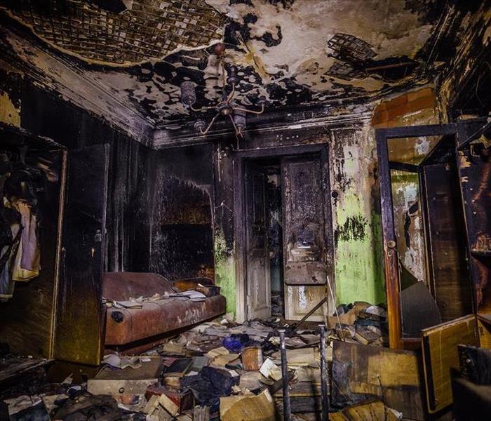 A home with fire damaged items in a living room. 