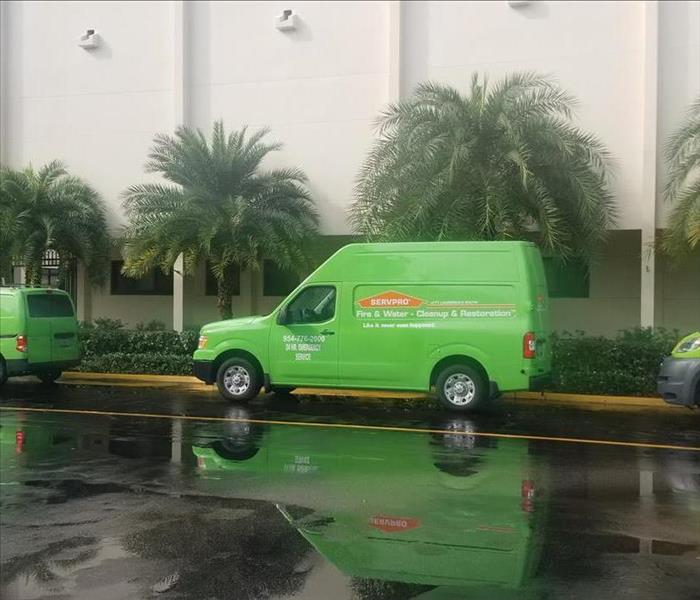 Three SERVPRO service vehicles outside the John A. Kelly Science and Technology.