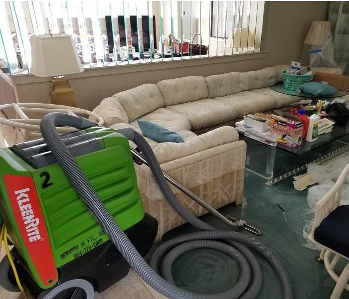 SERVPRO restoration equipment being used on water damaged carpet in living room