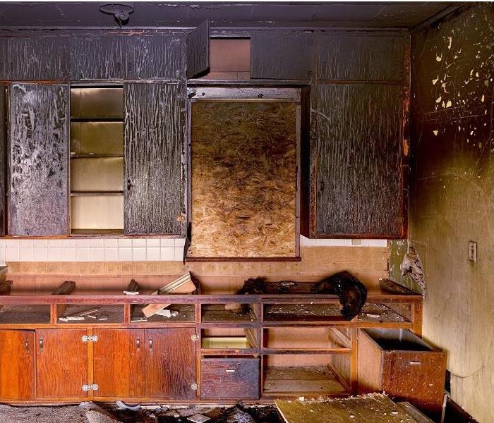 fire damaged kitchen; charred cabinets; smoke damaged walls